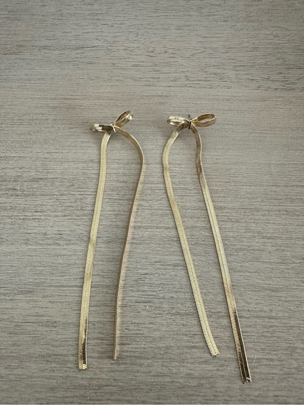 Long dangle gold bow earrings